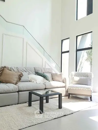 Spacious modern living room with high ceilings and elegant decor