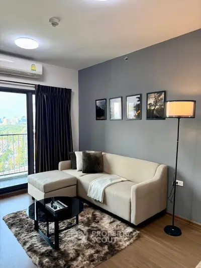 Modern living room with cozy sofa, stylish decor, and city view balcony in a chic apartment.