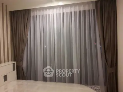Elegant living room with floor-to-ceiling curtains and modern decor