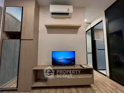 Modern living room with sleek wooden furniture and mounted air conditioner, featuring a flat-screen TV and stylish decor.