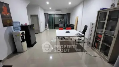 Spacious office space with modern furniture and large windows for natural light.