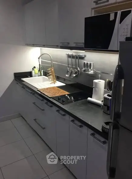 Modern kitchen with sleek cabinetry and stainless steel appliances.