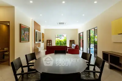Spacious modern living room with elegant dining area and garden view, perfect for family gatherings.