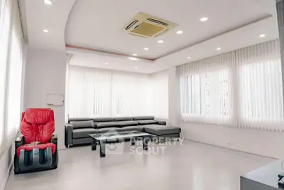 Spacious modern living room with sleek furniture and ample natural light