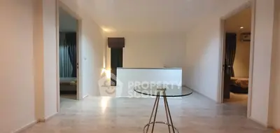 Spacious modern interior with glass table and light wood flooring
