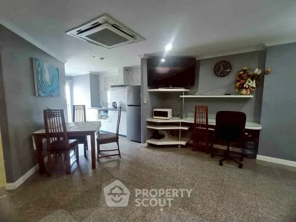 Spacious living area with modern kitchen and dining setup, featuring stylish decor and ample natural light.