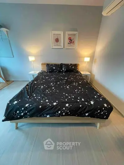 Modern bedroom with stylish decor and starry bedding, featuring soft lighting and minimalist design.