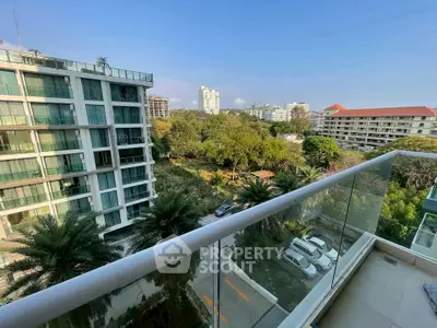 Stunning balcony view overlooking lush greenery and modern buildings