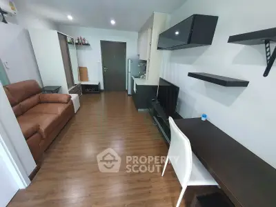 Modern living room with sleek furniture and wooden flooring in a stylish apartment.