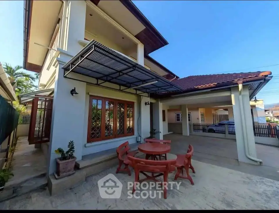 Spacious modern home with outdoor seating and covered parking area