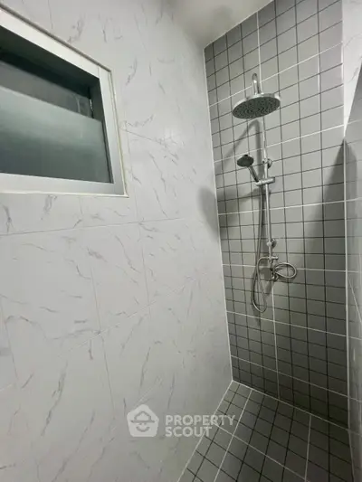 Modern bathroom with sleek shower and tiled walls