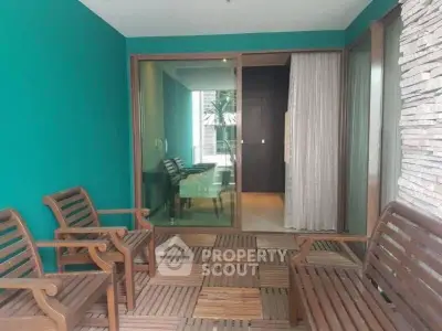 Charming balcony with wooden seating and sliding glass doors leading to a modern interior.