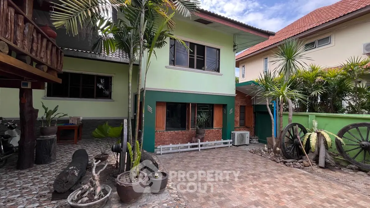Charming two-story home with lush garden and spacious courtyard, perfect for family living.