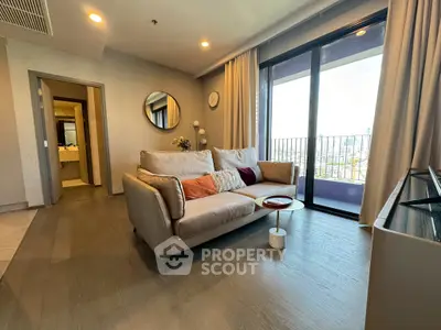 Modern living room with cozy sofa and balcony view in stylish apartment