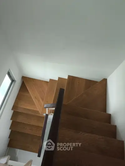 Modern wooden staircase with sleek design and natural light