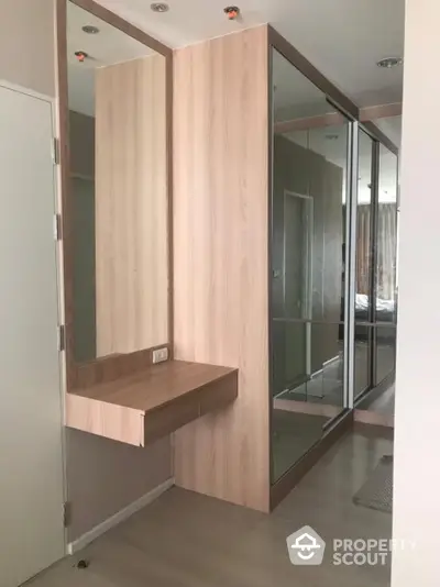 Modern bedroom with mirrored wardrobe and wooden vanity