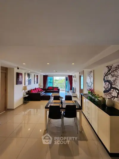 Spacious open-plan living room with modern decor and garden view
