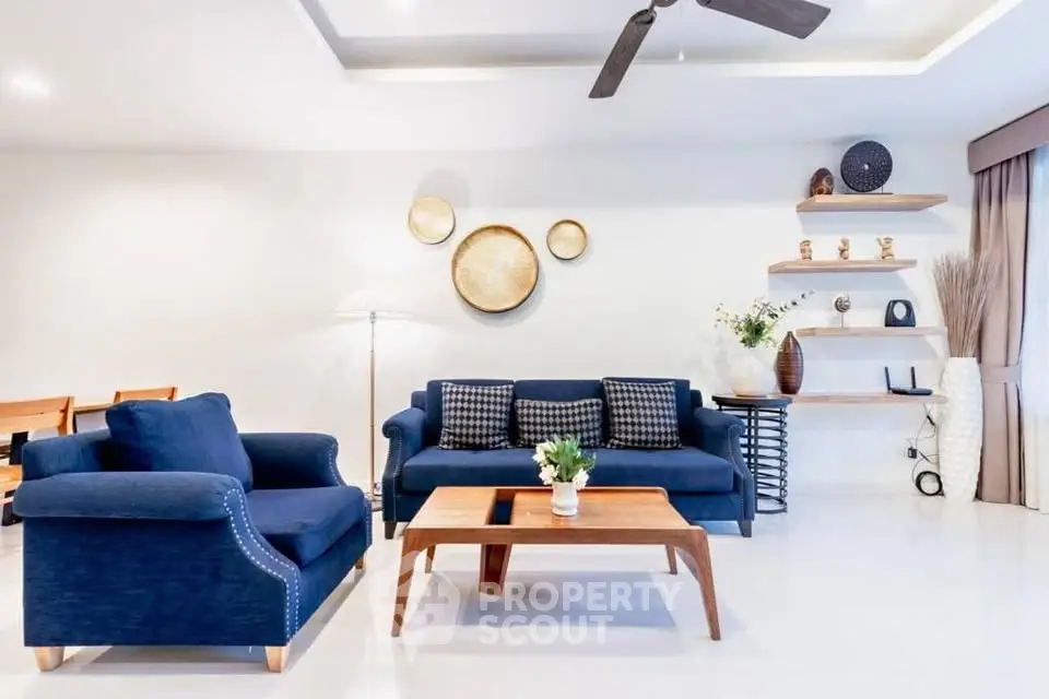 Modern living room with stylish blue sofas and elegant decor