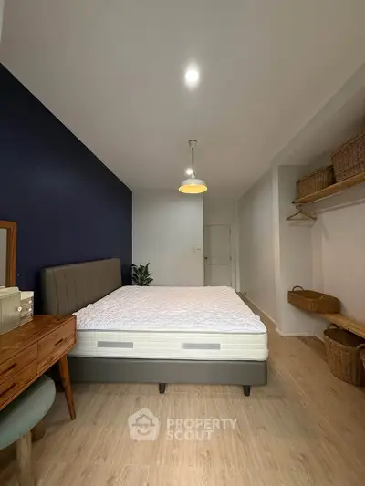 Modern bedroom with stylish furniture and cozy ambiance, featuring a comfortable bed and elegant decor.