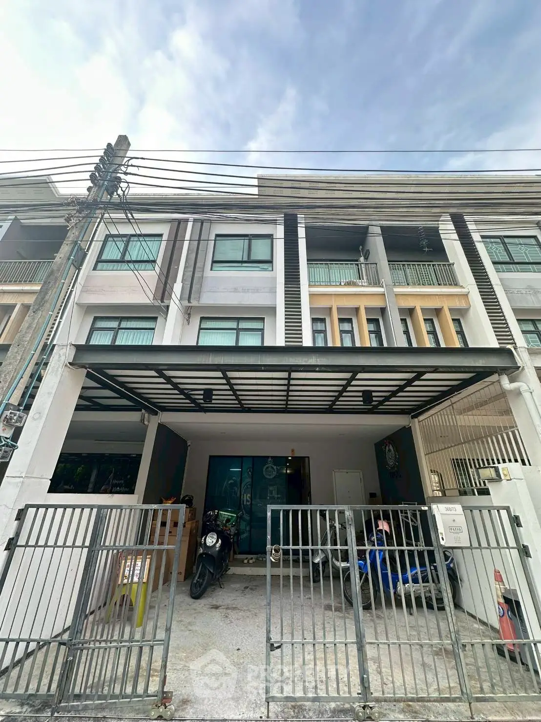 Modern townhouse exterior with gated parking and sleek design