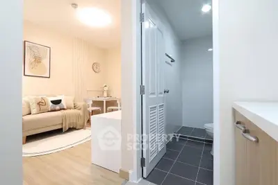 Modern apartment interior with cozy living room and adjacent bathroom