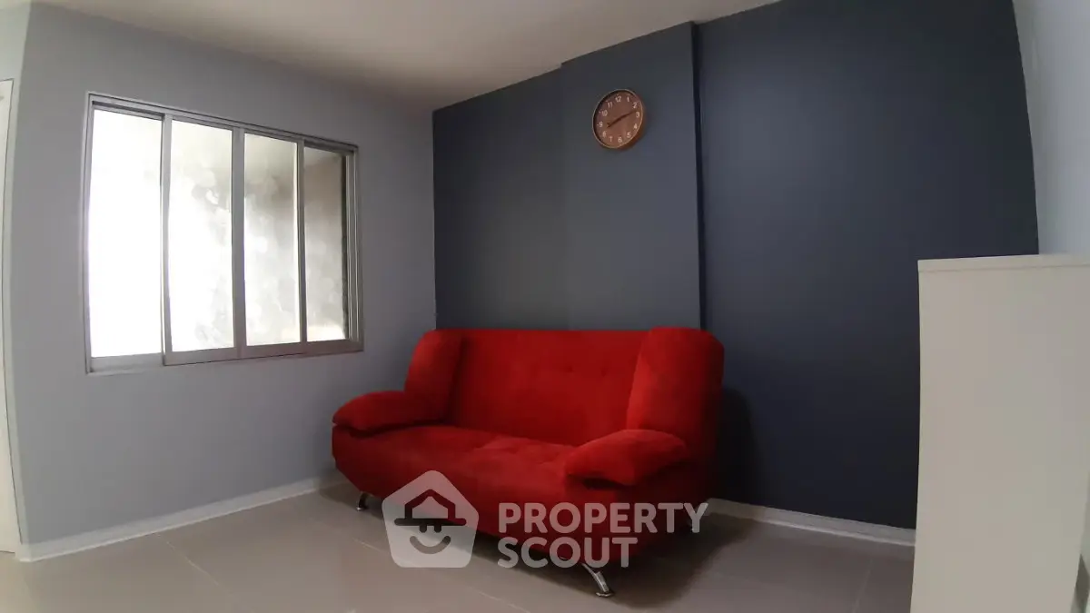 Modern living room with red sofa and stylish decor