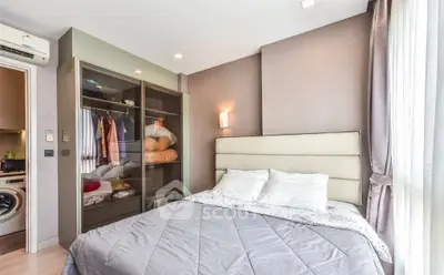 Modern bedroom with open closet and washing machine in stylish apartment