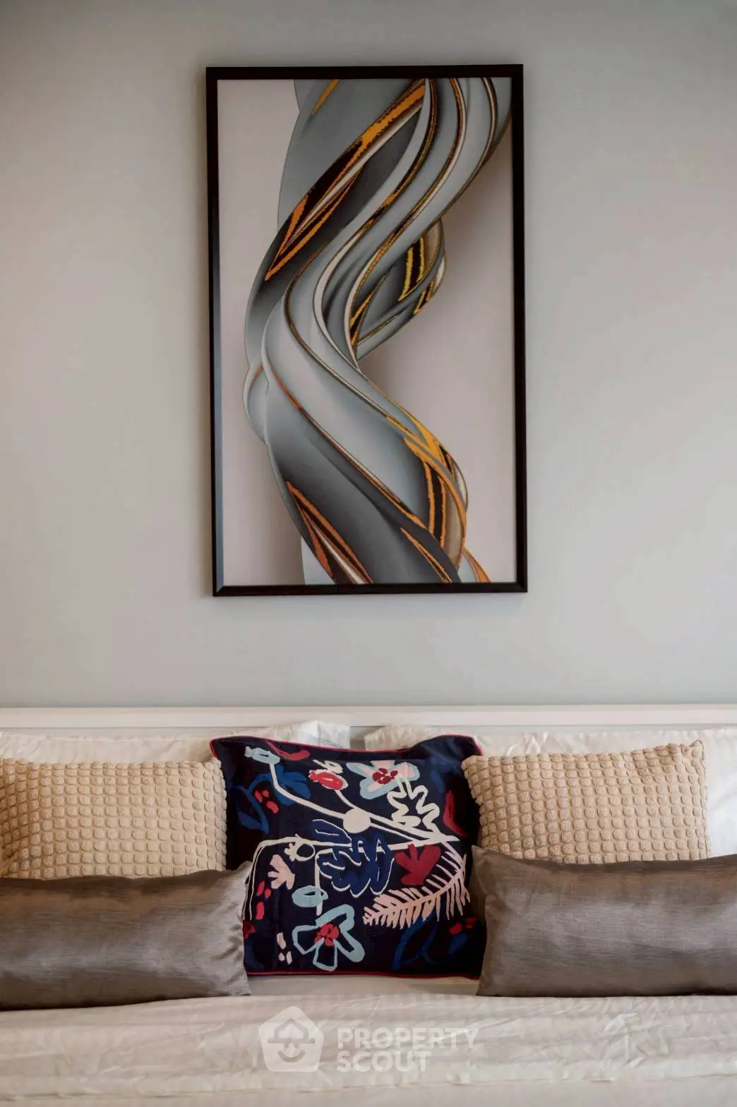Stylish living room with modern art and cozy cushions, perfect for relaxation.