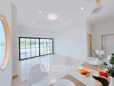 Bright dining area with modern decor and large windows offering natural light.