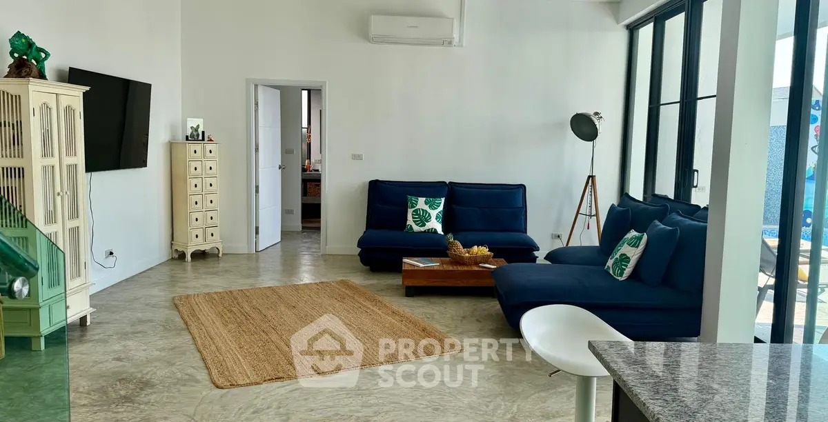 Spacious modern living room with stylish blue sofas and natural light