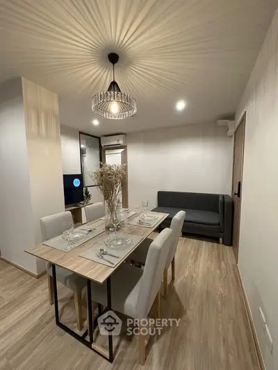 Modern dining area with elegant lighting and stylish decor in a cozy apartment setting.