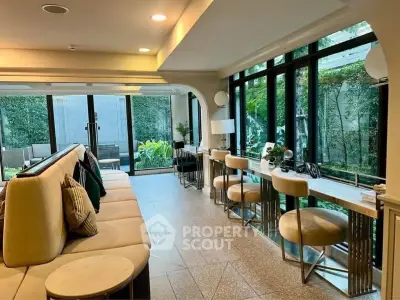 Luxurious living room with garden view and elegant decor, perfect for modern living.