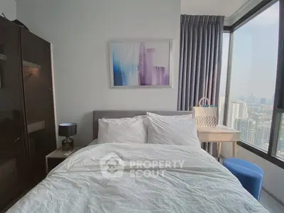 Modern bedroom with city view, featuring stylish decor and large windows for natural light.