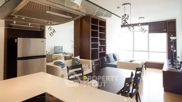 Modern open-layout kitchen and living room with stylish decor and natural light