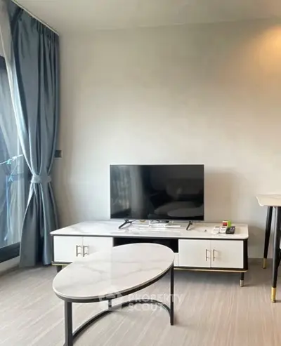 Modern living room with sleek TV setup and elegant furnishings.