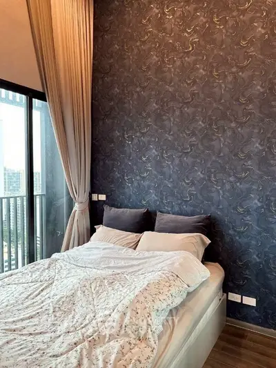 Modern bedroom with stylish wallpaper and city view balcony