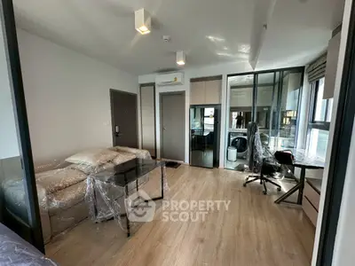Modern living room with glass partition and wooden flooring