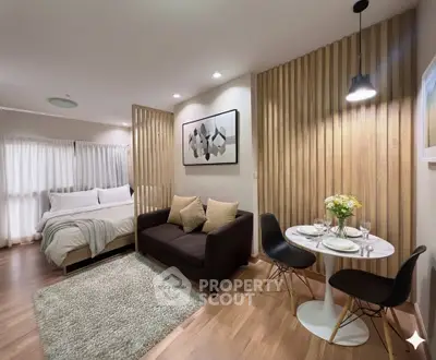 Modern studio apartment with cozy living area and stylish dining space