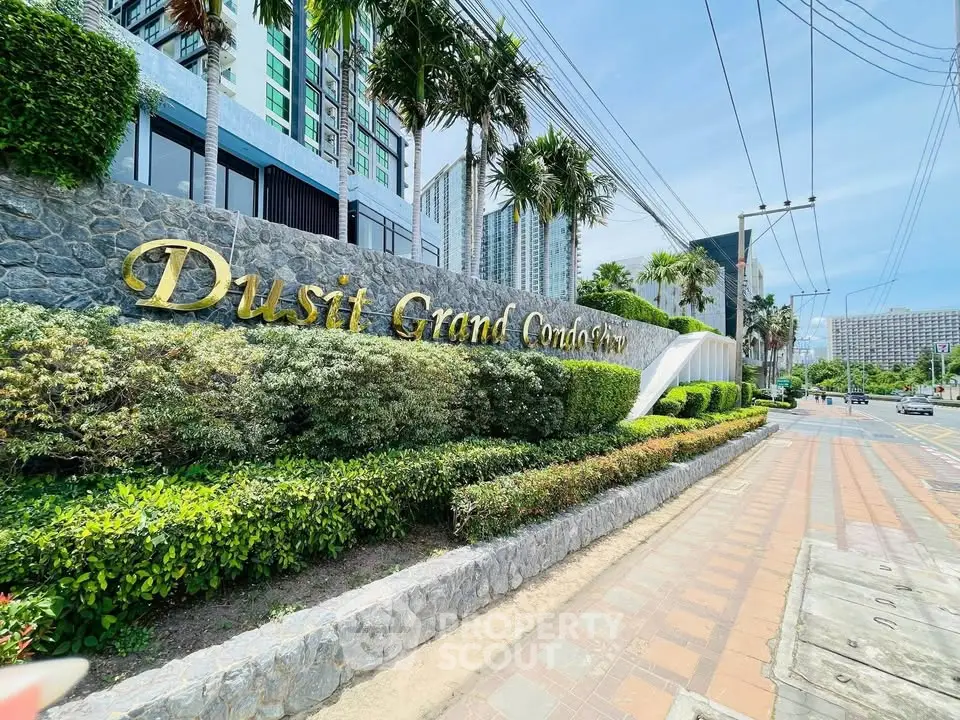 Luxurious entrance of Dusit Grand Condo View with lush greenery and modern architecture.