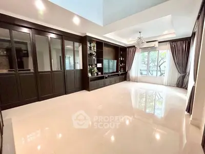 Spacious living room with elegant built-in cabinets and large windows for natural light.