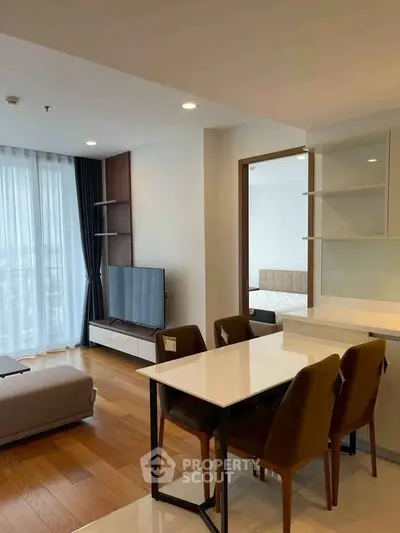 Modern open-plan living and dining area with natural light and stylish furnishings.