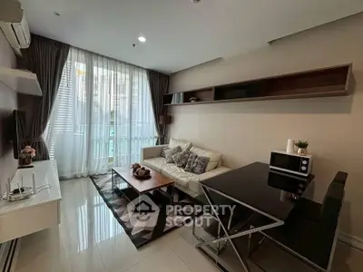 Modern living room with sleek furniture and large window for natural light.