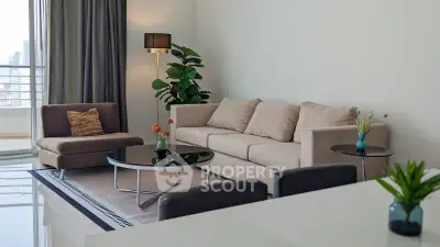 Spacious modern living room with elegant furniture and city view balcony.