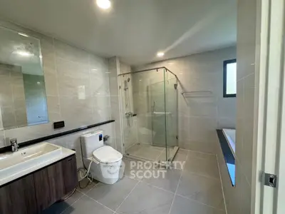 Modern bathroom with glass shower and sleek fixtures in luxury home