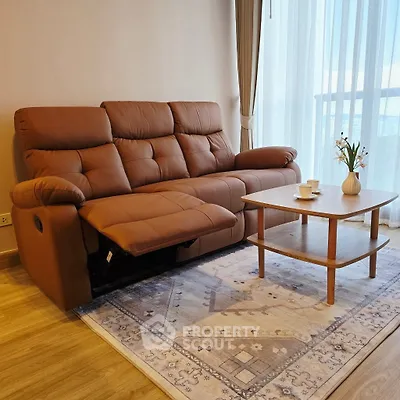 Cozy living room with plush brown sofa and elegant coffee table near large window
