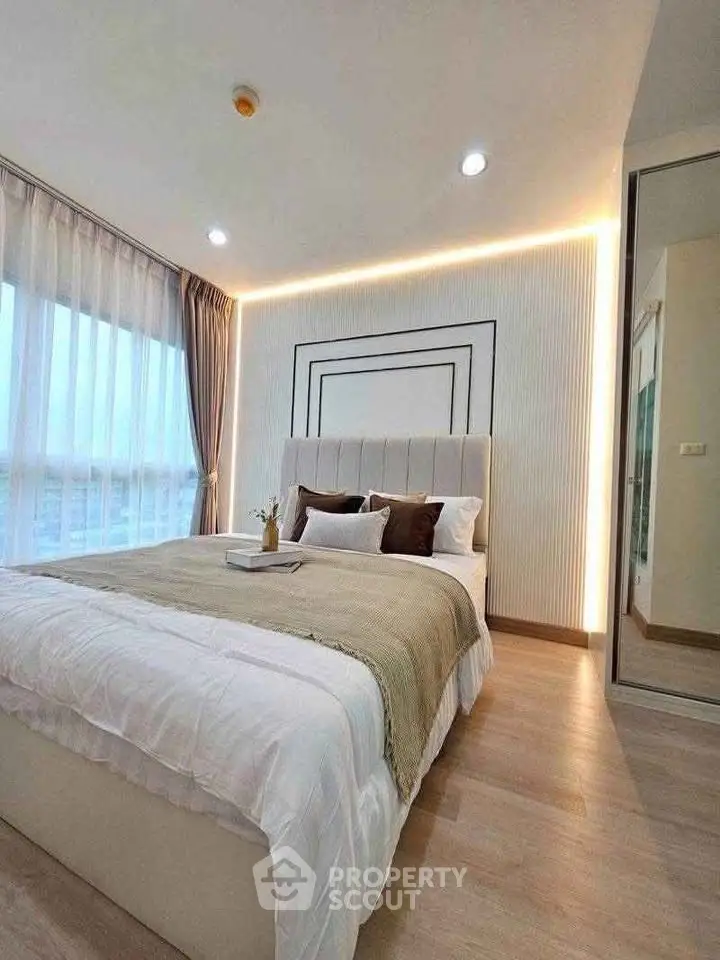 Luxurious bedroom with modern decor and large windows offering natural light and stunning views.