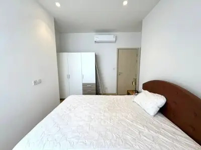 Spacious bedroom with modern furniture and air conditioning unit