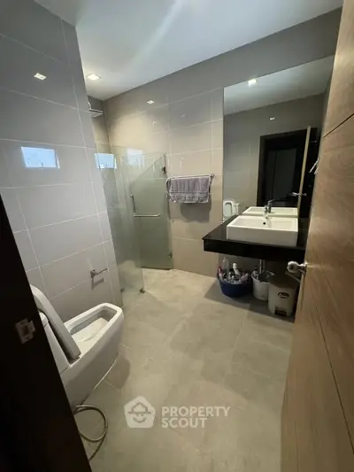 Modern bathroom with sleek design, glass shower, and contemporary fixtures in a stylish home.