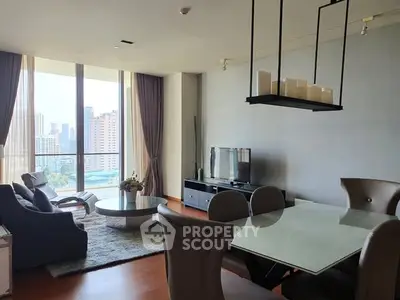 Luxurious living room with city view, modern furniture, and elegant decor.
