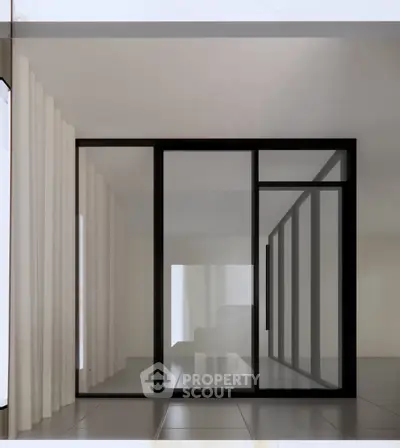 Modern minimalist interior with large glass sliding doors and sleek design.
